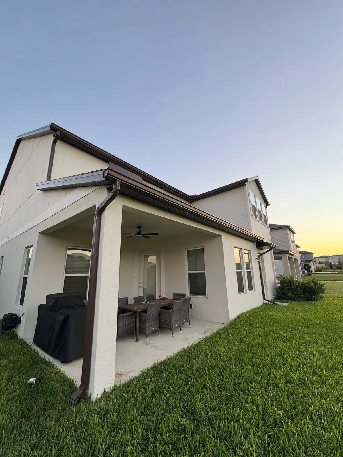 Covered rear patio roofline with gutters