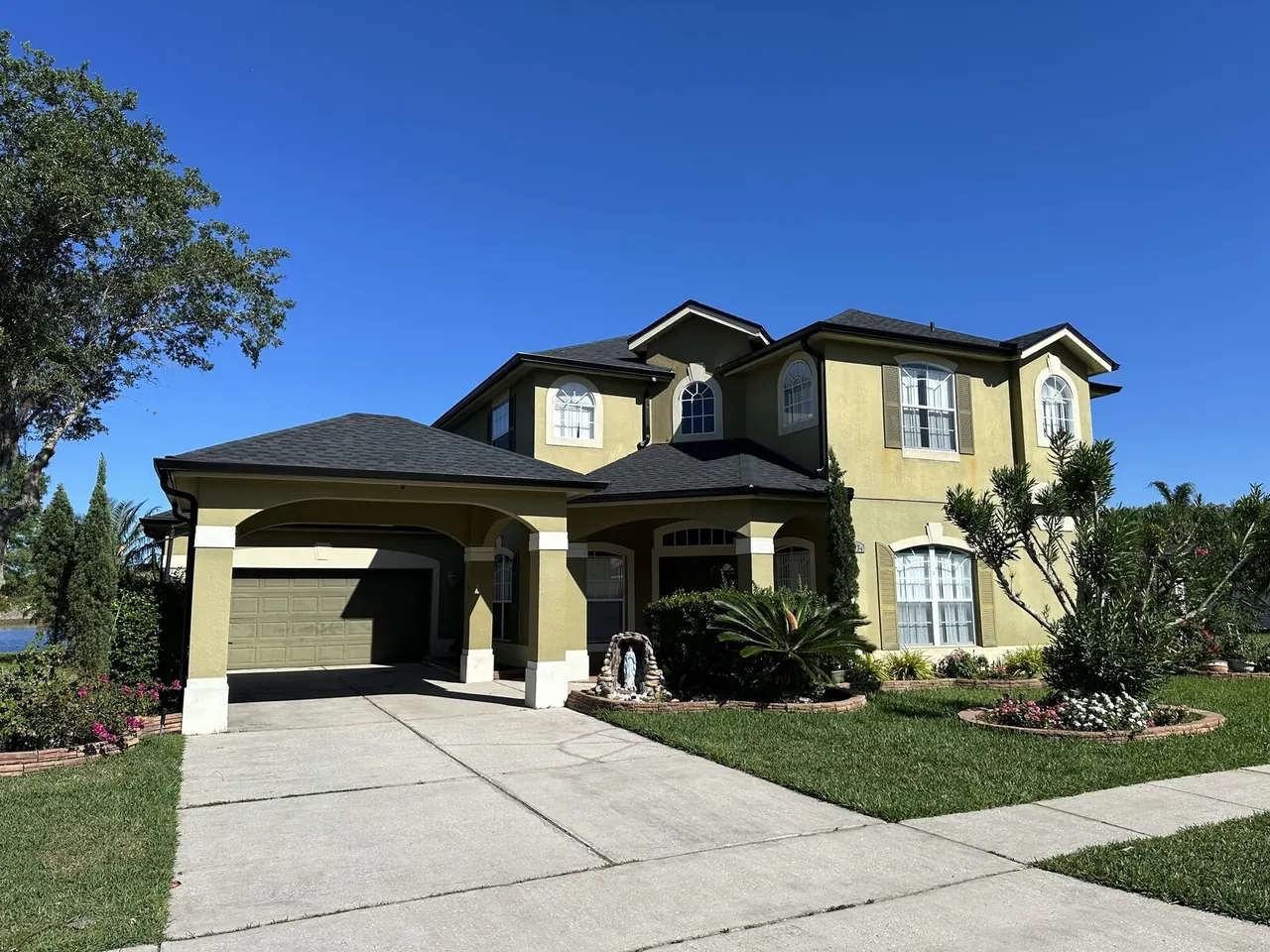 Two-story Florida home with a dark roofline and new gutter system
