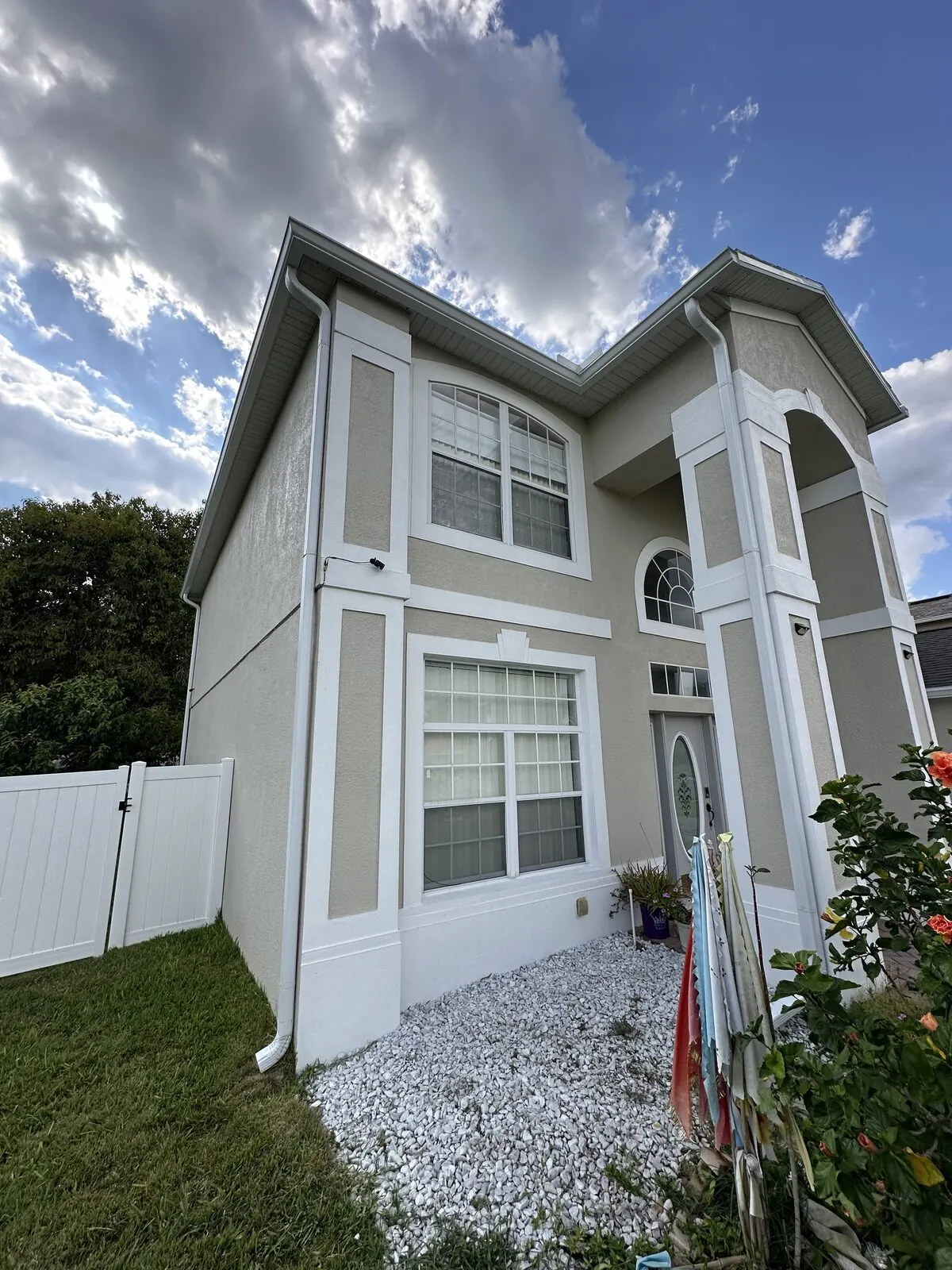 Tall white downspout on a two-story home