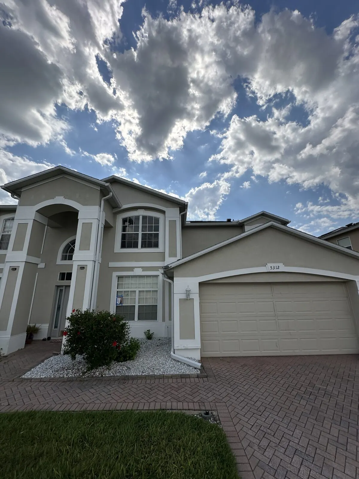 Two-story garage elevation with white gutters