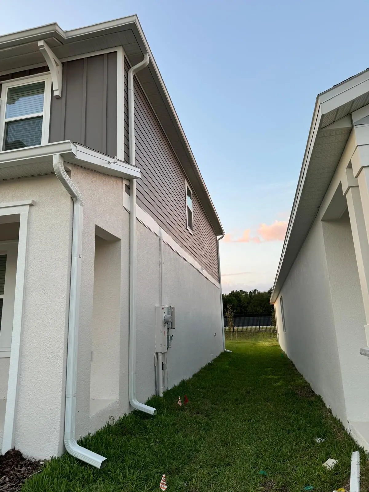 White downspouts running down a side elevation