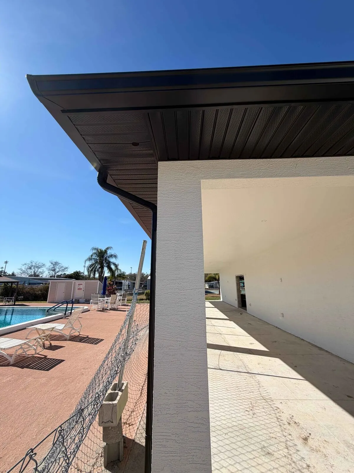 Dark vented soffit on a poolside structure