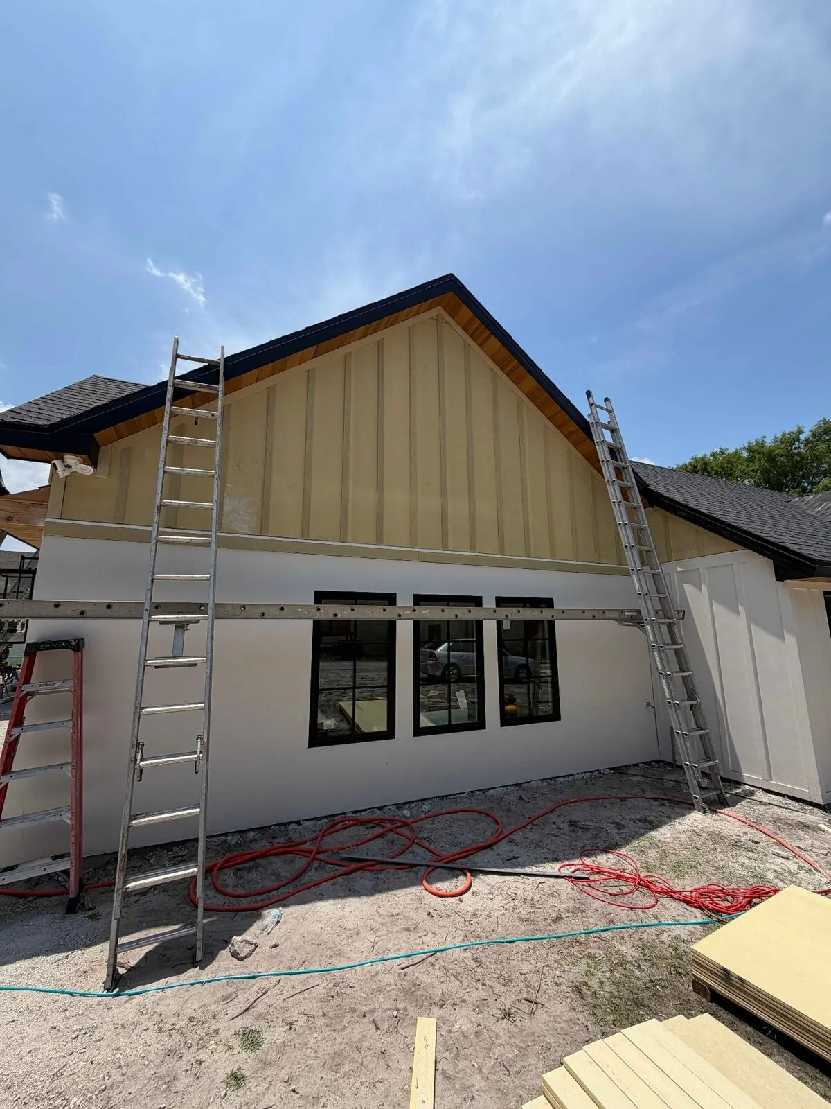 Board-and-batten siding project with ladders