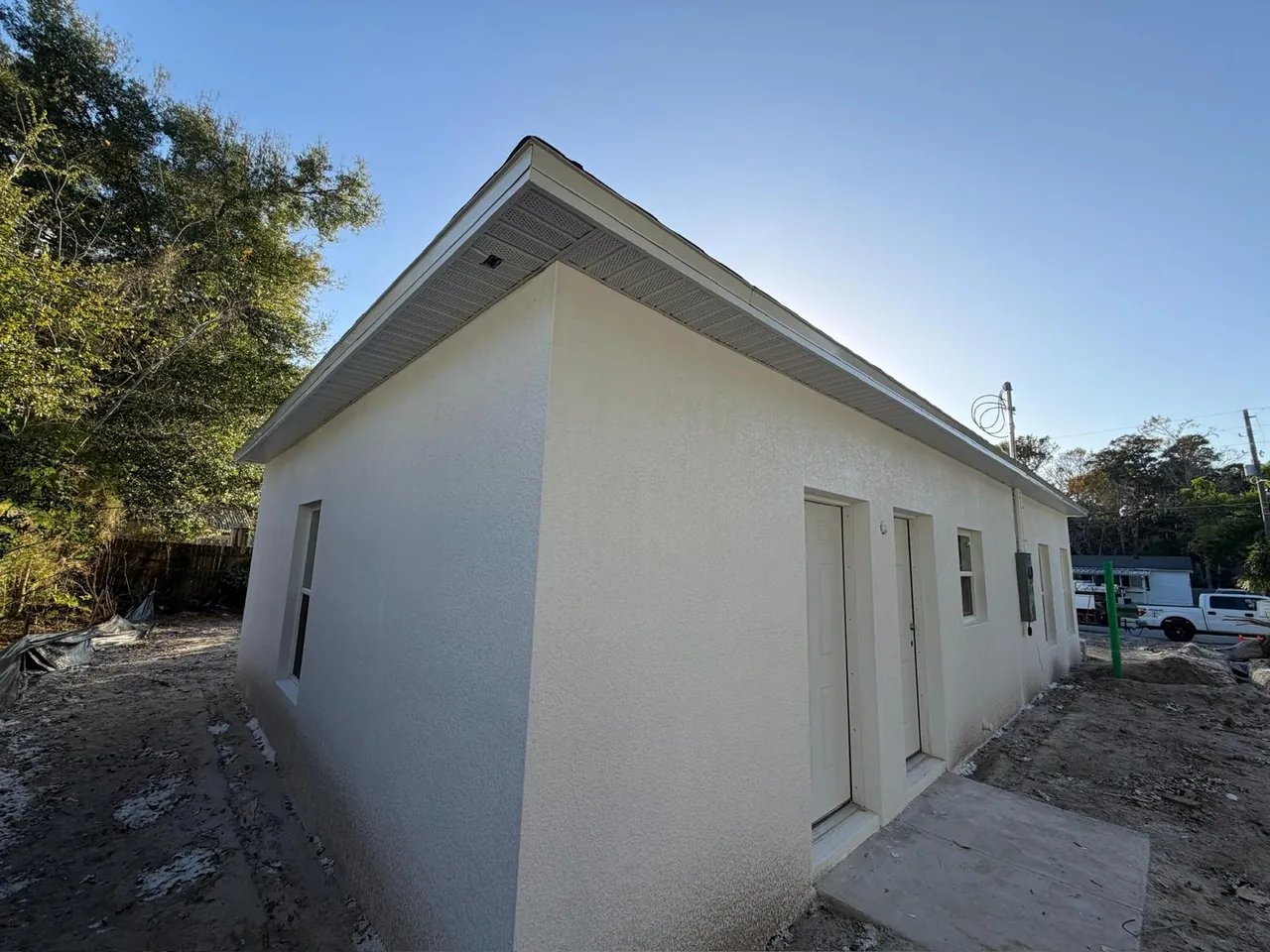 White stucco building with vented soffit along the full roofline